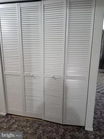 a view of a bathroom with a sink a window and a mirror