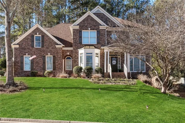 a front view of a house with a yard