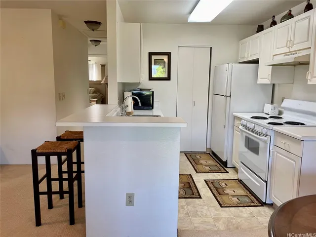 a kitchen with stainless steel appliances a refrigerator and a stove top oven