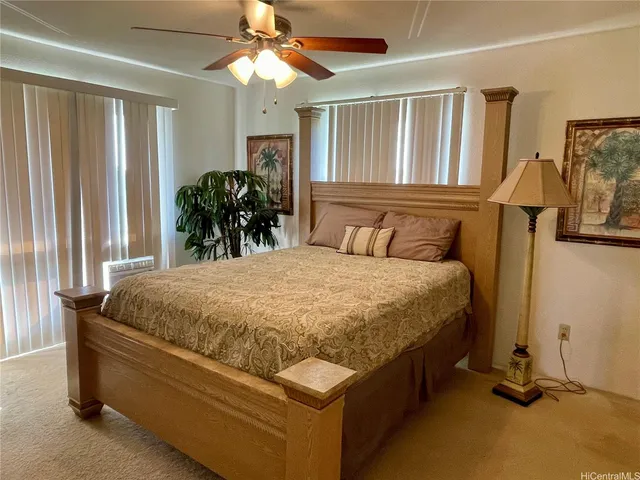 a bed sitting in a spacious bedroom next to a window
