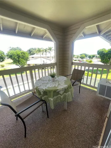 a view of a balcony with furniture and outside view