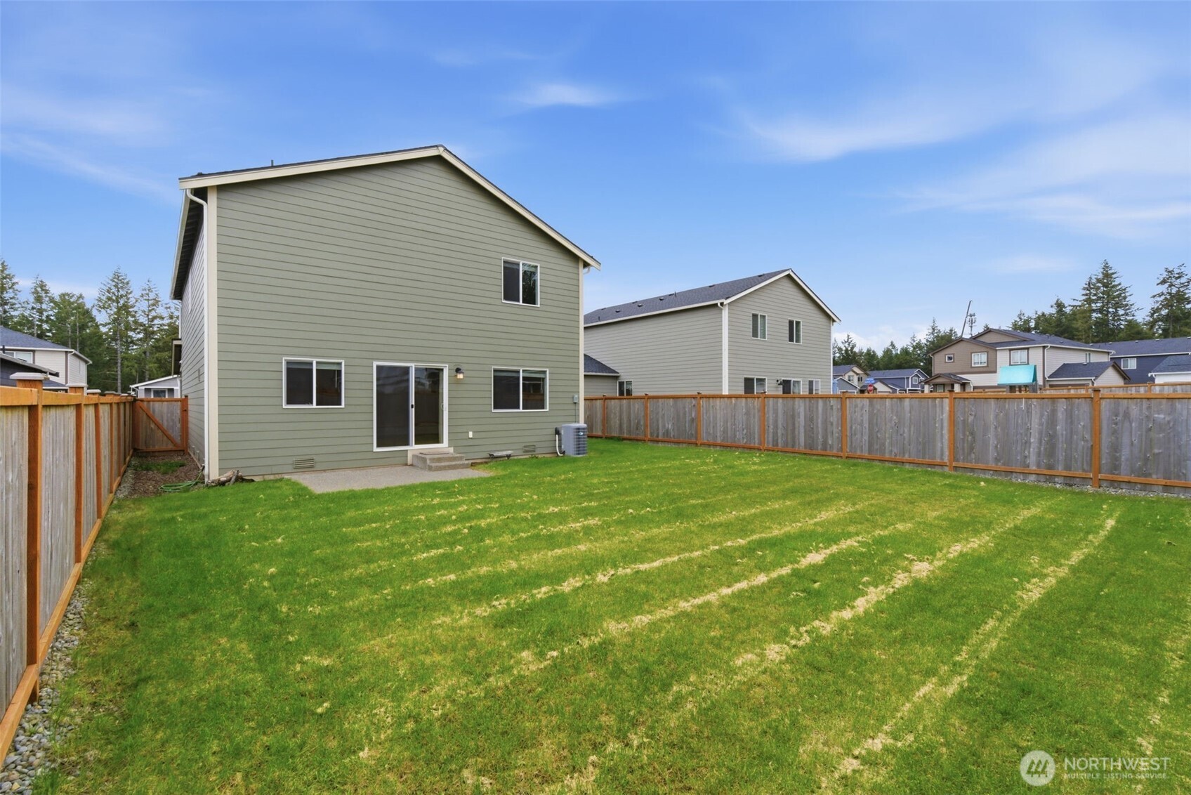 430 Northeast Ridge Point Boulevard Belfair, WA 98528 - Photo 33 of 39 a view of a backyard with plants and large trees