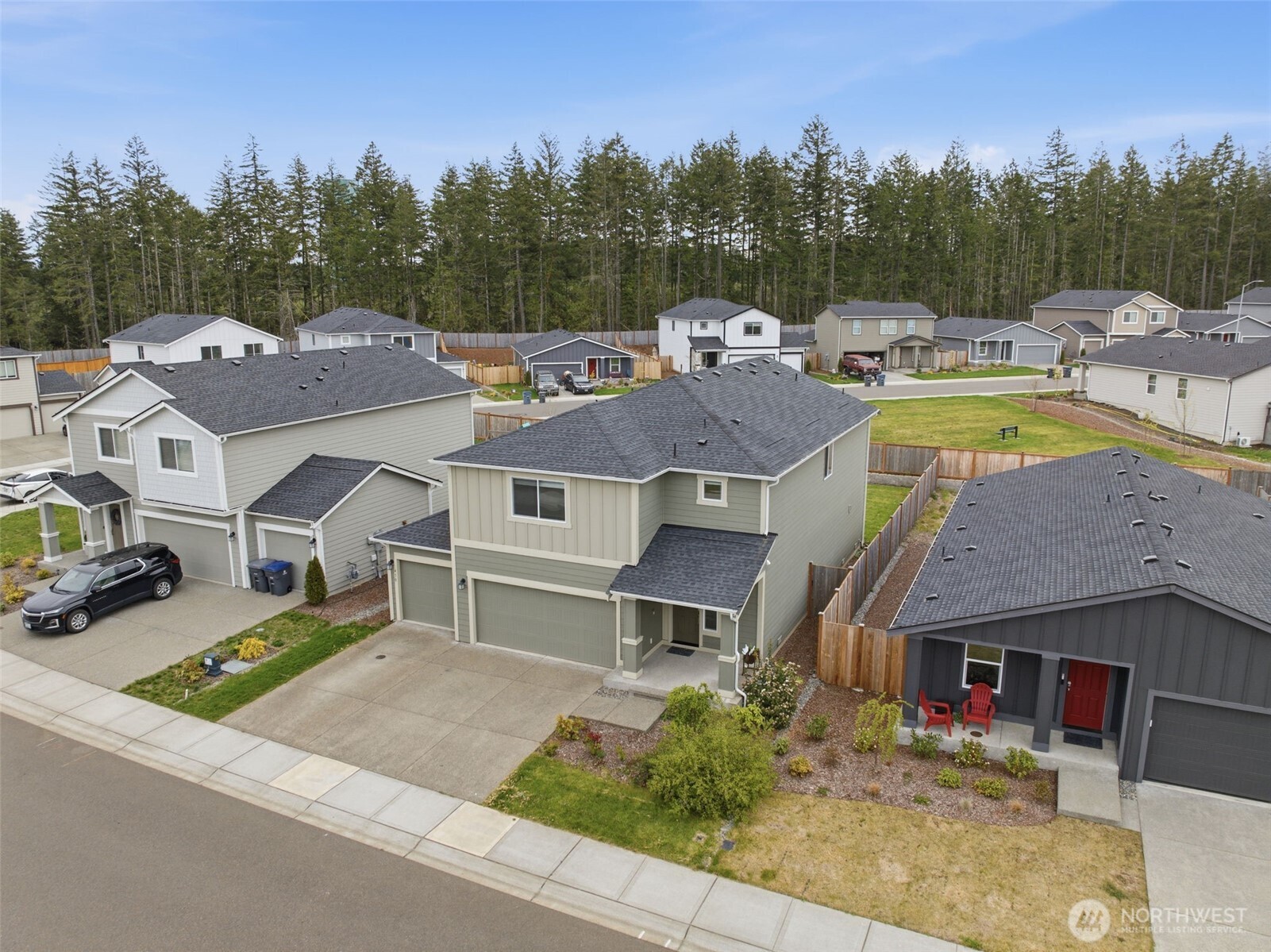 430 Northeast Ridge Point Boulevard Belfair, WA 98528 - Photo 35 of 39 a view of house with outdoor space swimming pool and trees in the background
