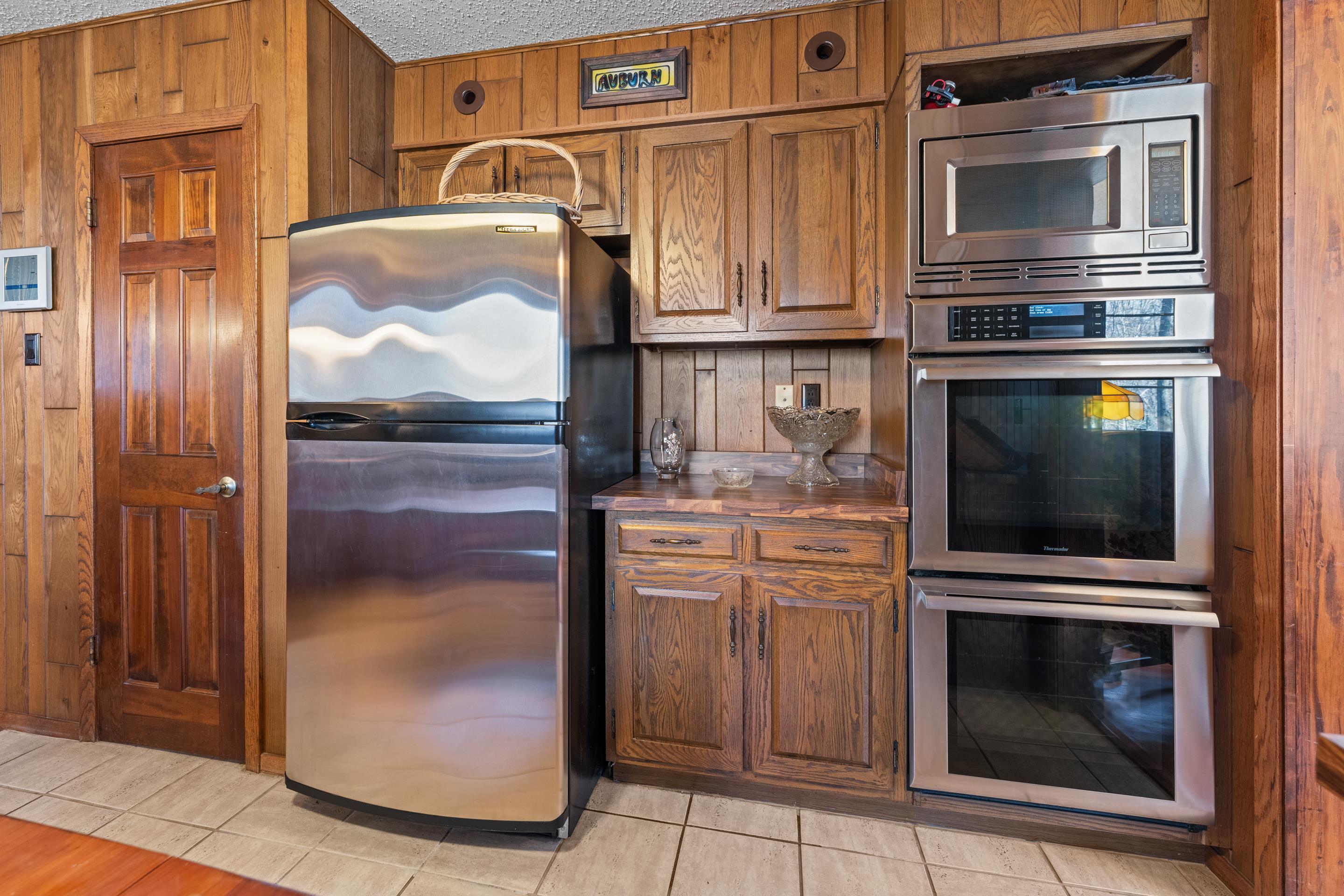 2989 Little John Road Millington, TN 38053 - Photo 12 of 34 a kitchen with granite countertop a refrigerator and a stove