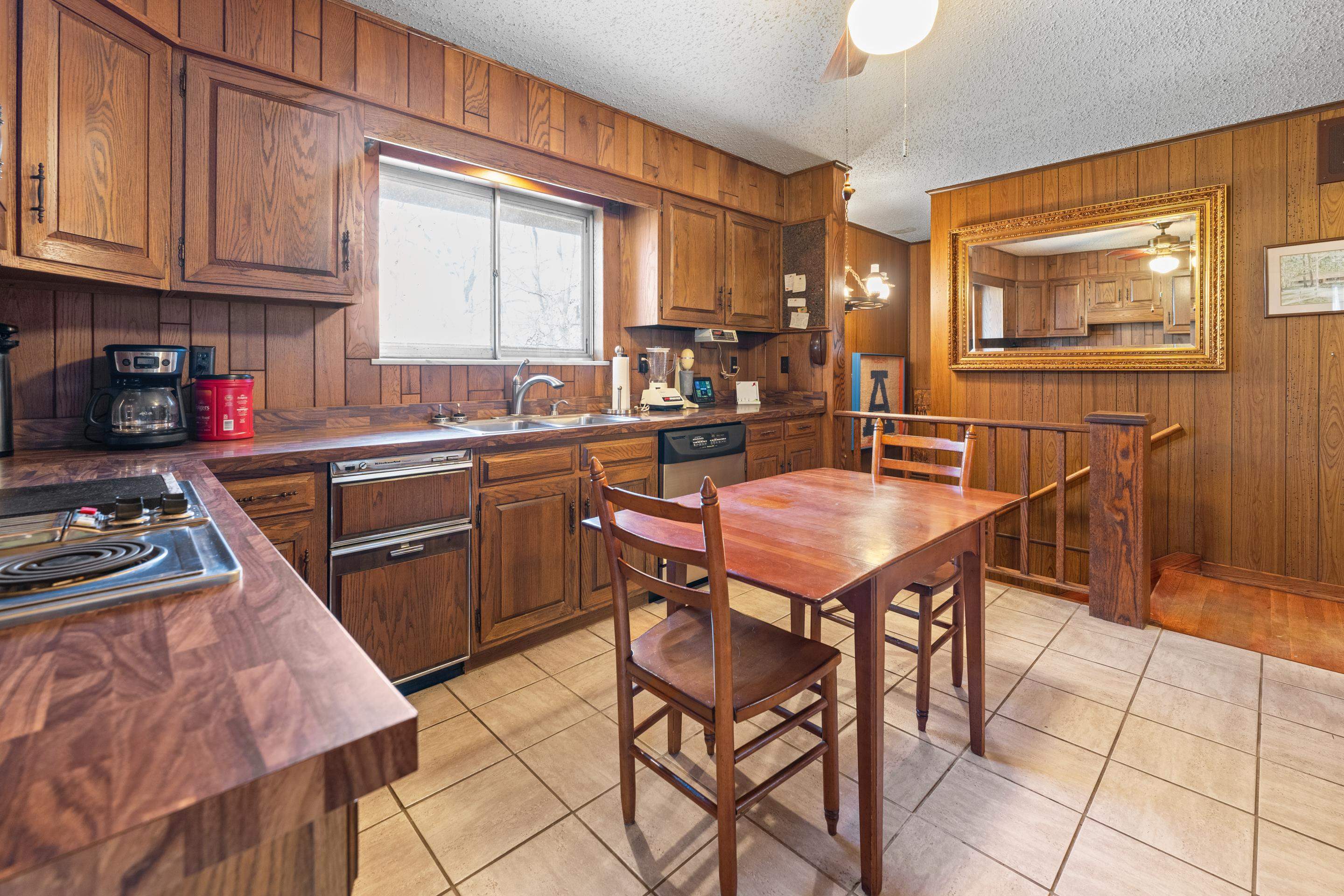 2989 Little John Road Millington, TN 38053 - Photo 13 of 34 a kitchen with stainless steel appliances granite countertop a sink a stove a refrigerator cabinets and dining table