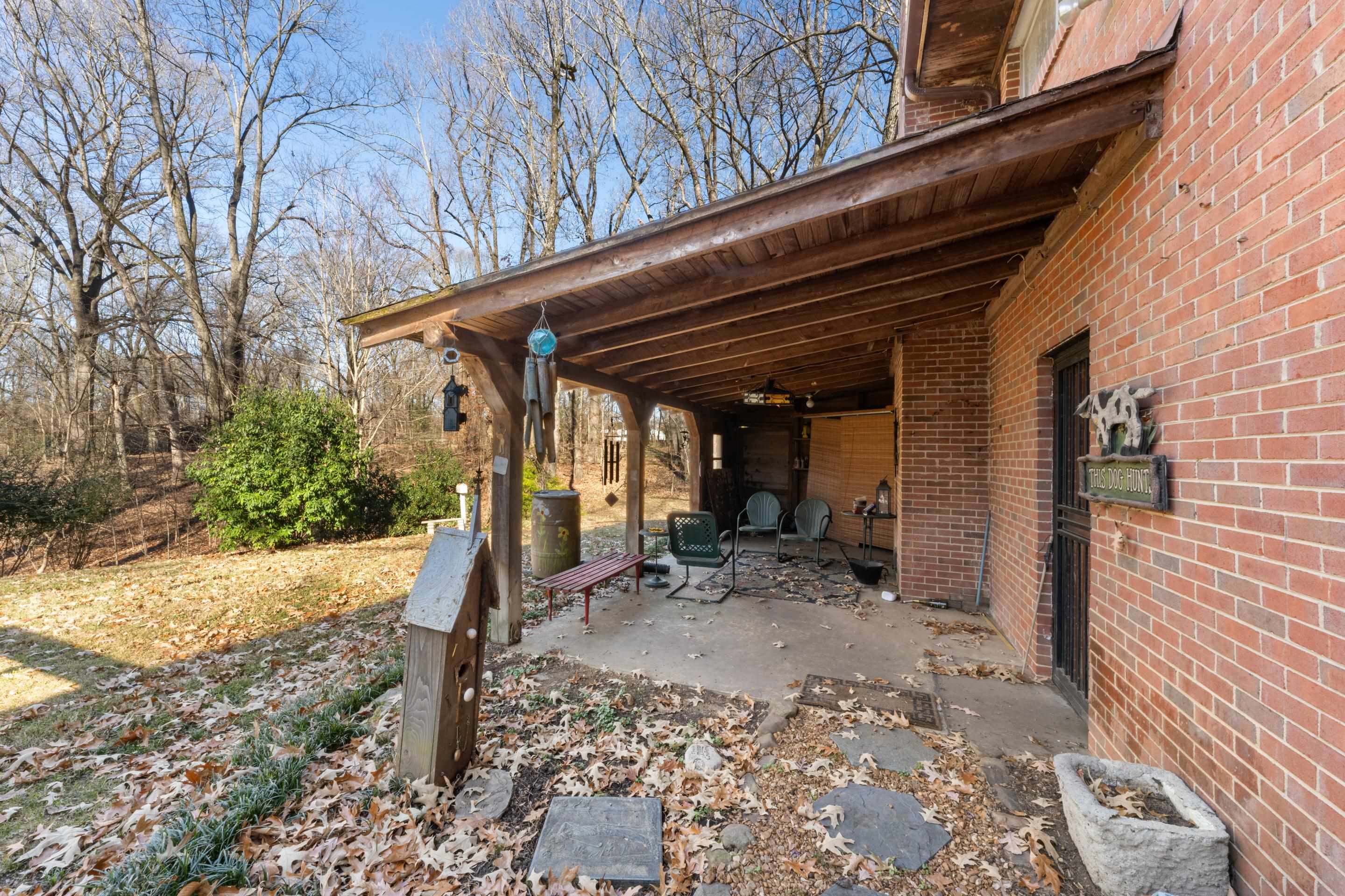 2989 Little John Road Millington, TN 38053 - Photo 28 of 34 a view of a patio with table and chairs under an umbrella with wooden fence