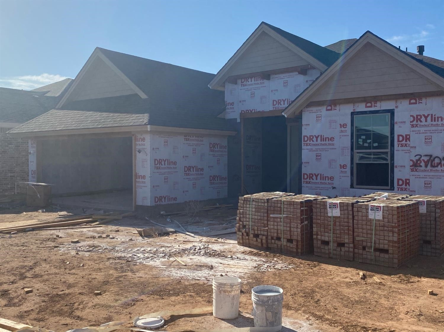 2709 138th Street Lubbock, TX 79423 - Photo 2 of 10 a brick house with large windows and wooden fence
