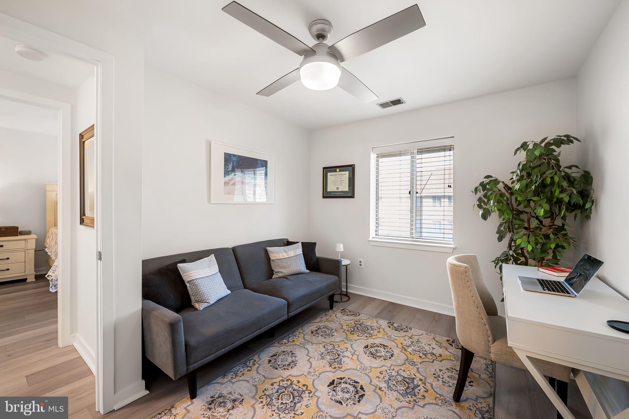 120 West Barre Street, Unit R 042 Baltimore, MD 21201 - Photo 16 of 32 a living room with furniture and a potted plant