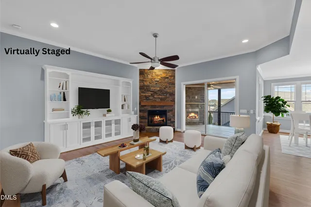 a living room with furniture a rug and a floor to ceiling window