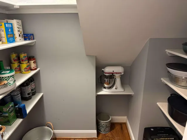 an empty room with a window and a ceiling fan