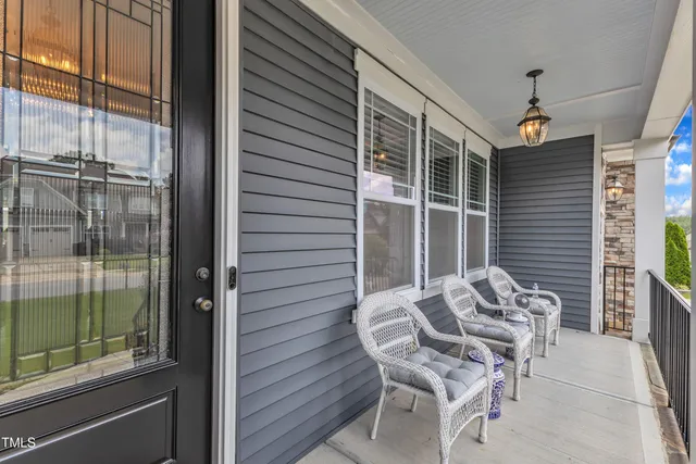 a living room with furniture kitchen view and a chandelier