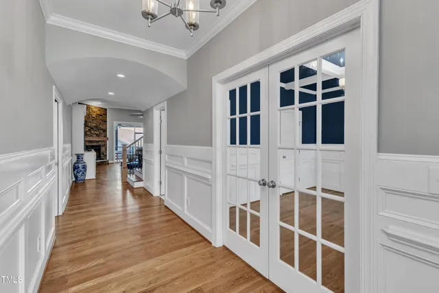 a kitchen with a counter space refrigerator and wooden floor