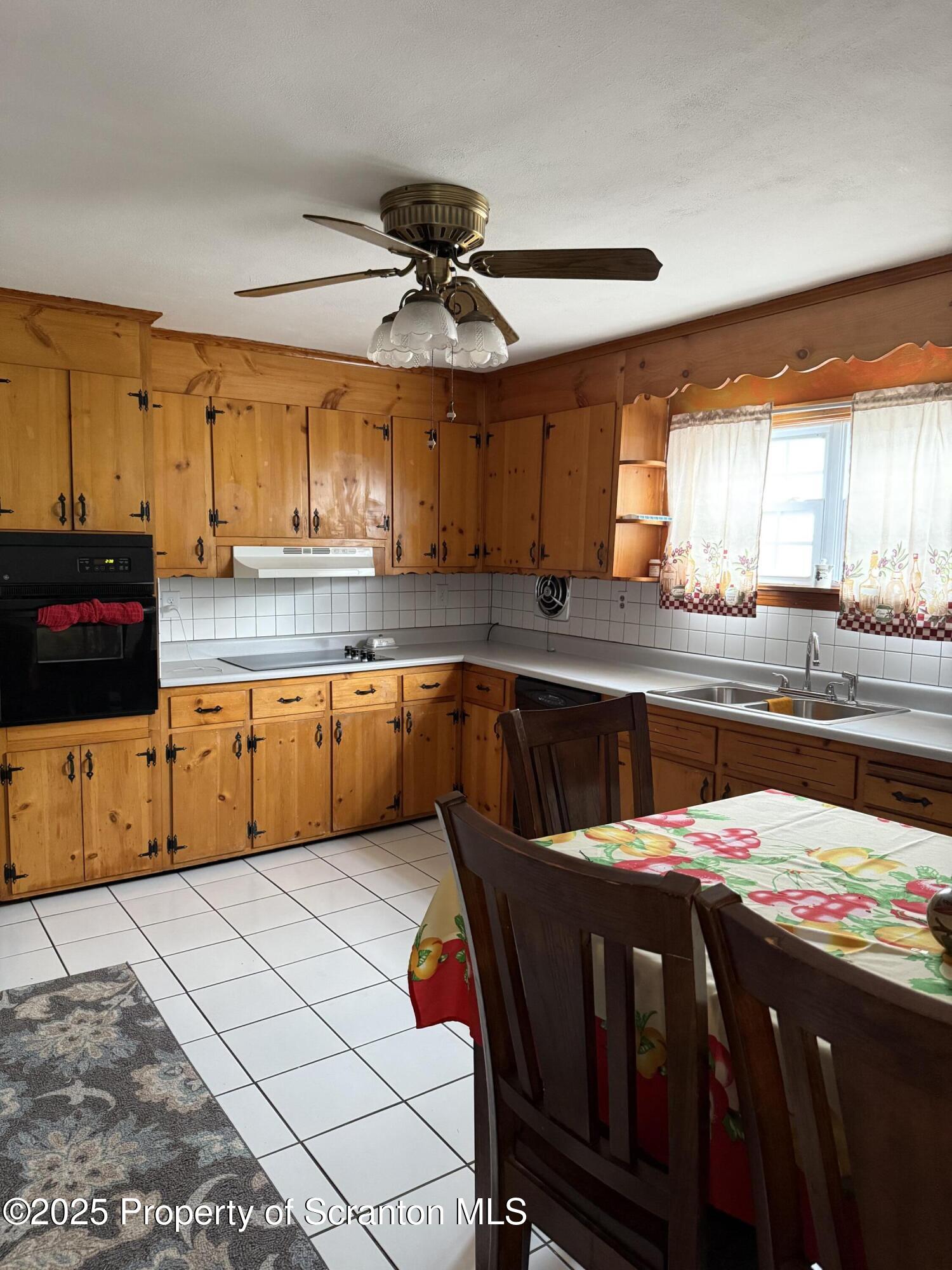 95 Farview Street Carbondale, PA 18407 - Photo 2 of 12 a kitchen with stainless steel appliances kitchen island granite countertop a sink and cabinets