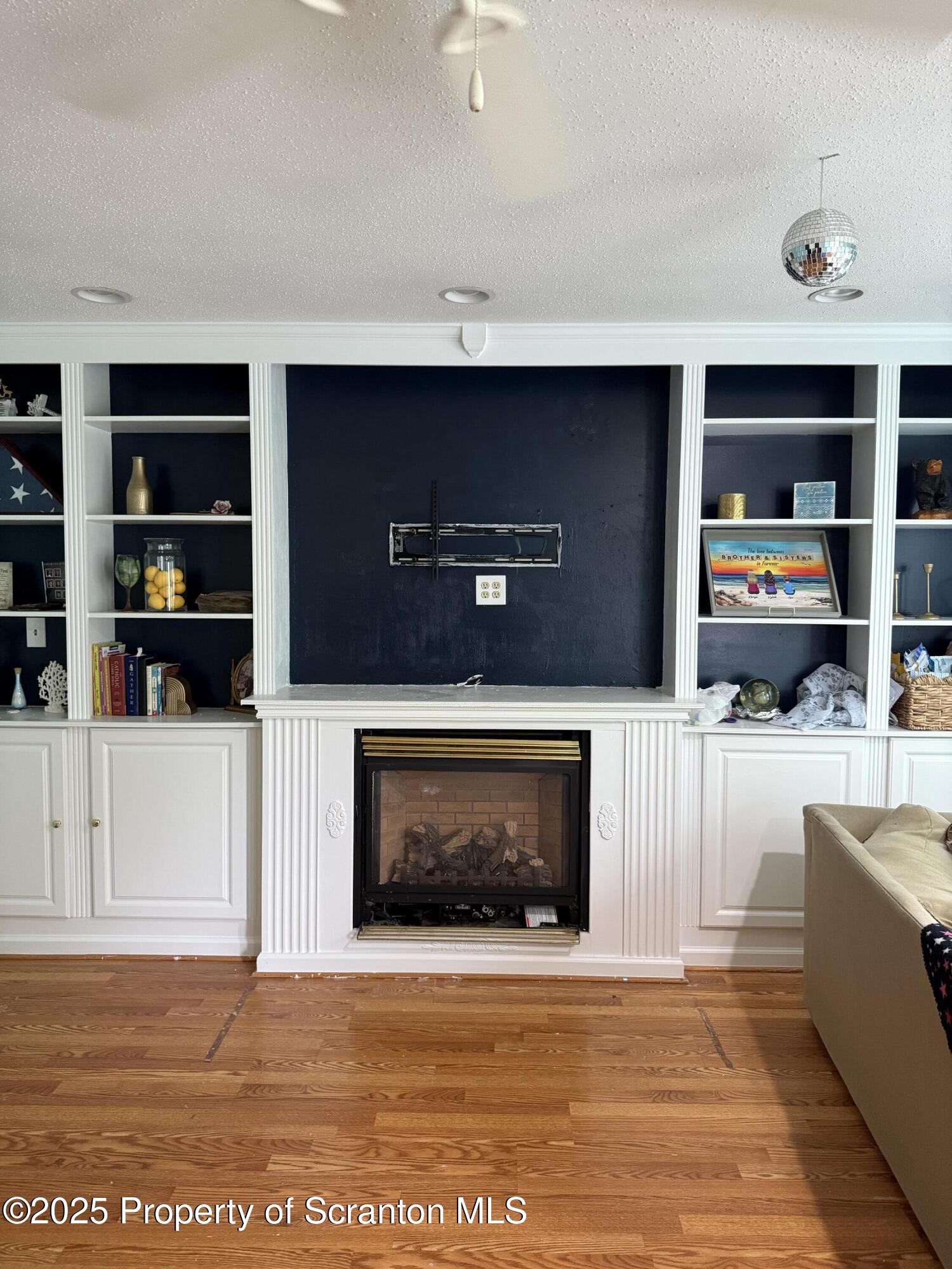 95 Farview Street Carbondale, PA 18407 - Photo 3 of 12 a living room with furniture a flat screen tv and a fireplace