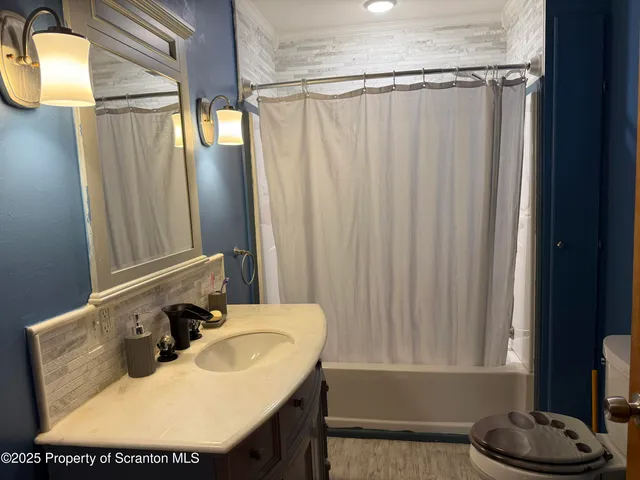 a bathroom with a sink a mirror and a tub