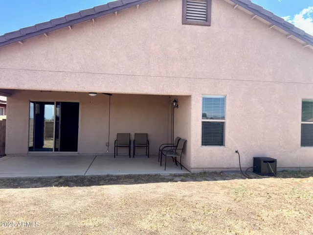 a view of a house with a yard and sitting space