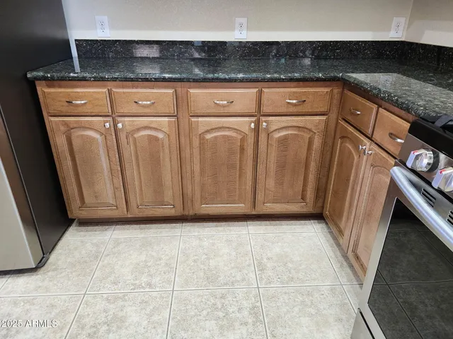 a view of a utility room with granite countertop cabinets