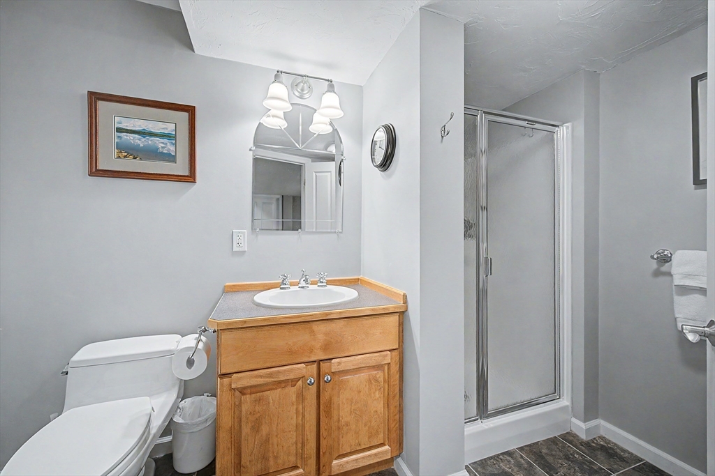 270 Mendon Road Sutton, MA 01590 - Photo 37 of 42 a bathroom with a toilet sink vanity and mirror