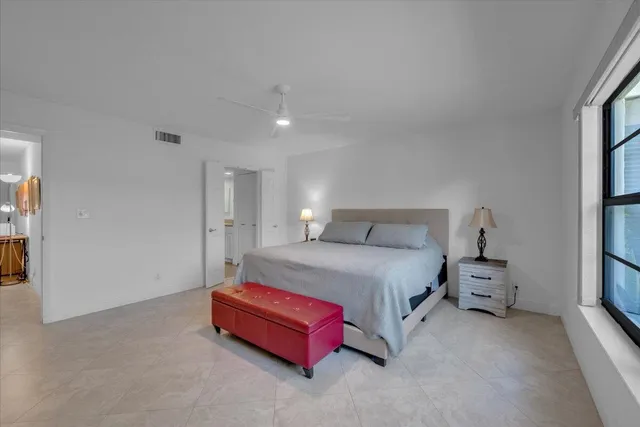 a spacious bedroom with a bed and a cabinets