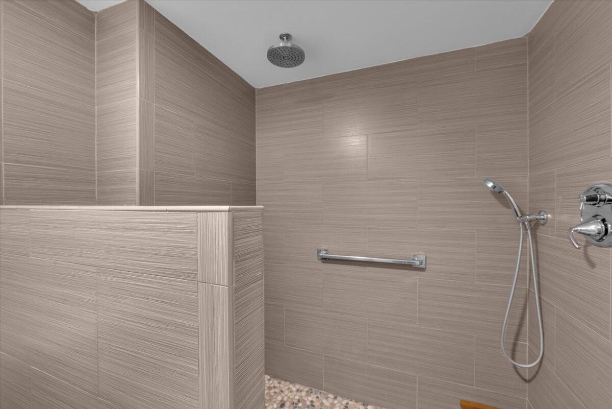 300 North Hwy A1A, Unit 103M Jupiter, FL 33477 - Photo 14 of 25 a bathroom with a shower