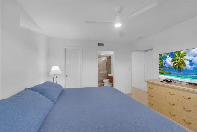 a bed room with a bed and painting on the wall