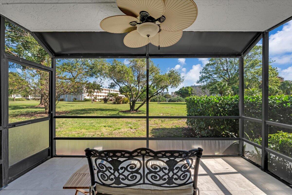 300 North Hwy A1A, Unit 103M Jupiter, FL 33477 - Photo 18 of 25 a view of a porch with furniture and a floor to ceiling window