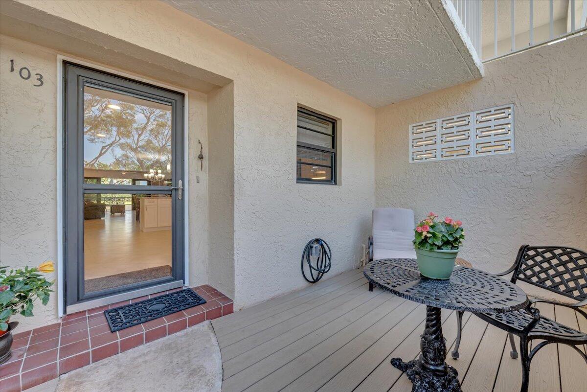 300 North Hwy A1A, Unit 103M Jupiter, FL 33477 - Photo 2 of 25 a view of a workspace with furniture and wooden floor