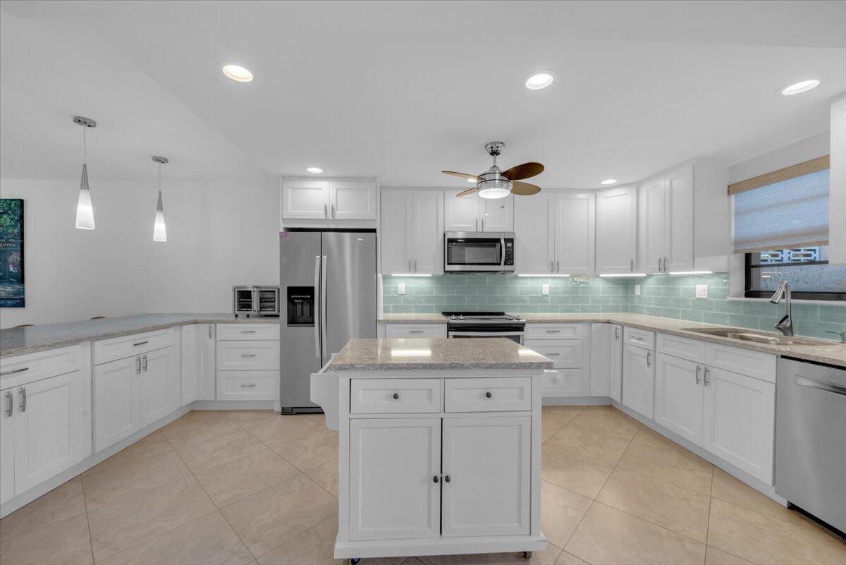300 North Hwy A1A, Unit 103M Jupiter, FL 33477 - Photo 4 of 25 a large kitchen with cabinets