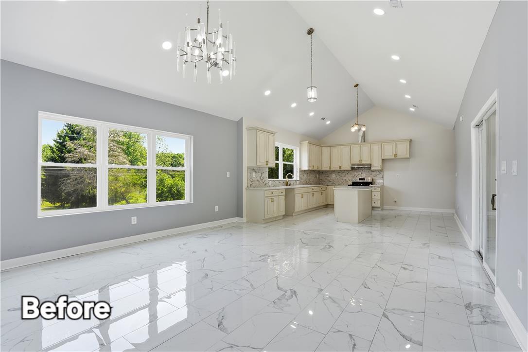 601 Fireline Road Bowmanstown, PA 18071 - Photo 24 of 27 A well-lit, open-concept kitchen and living area feature vaulted ceilings and polished tile flooring.