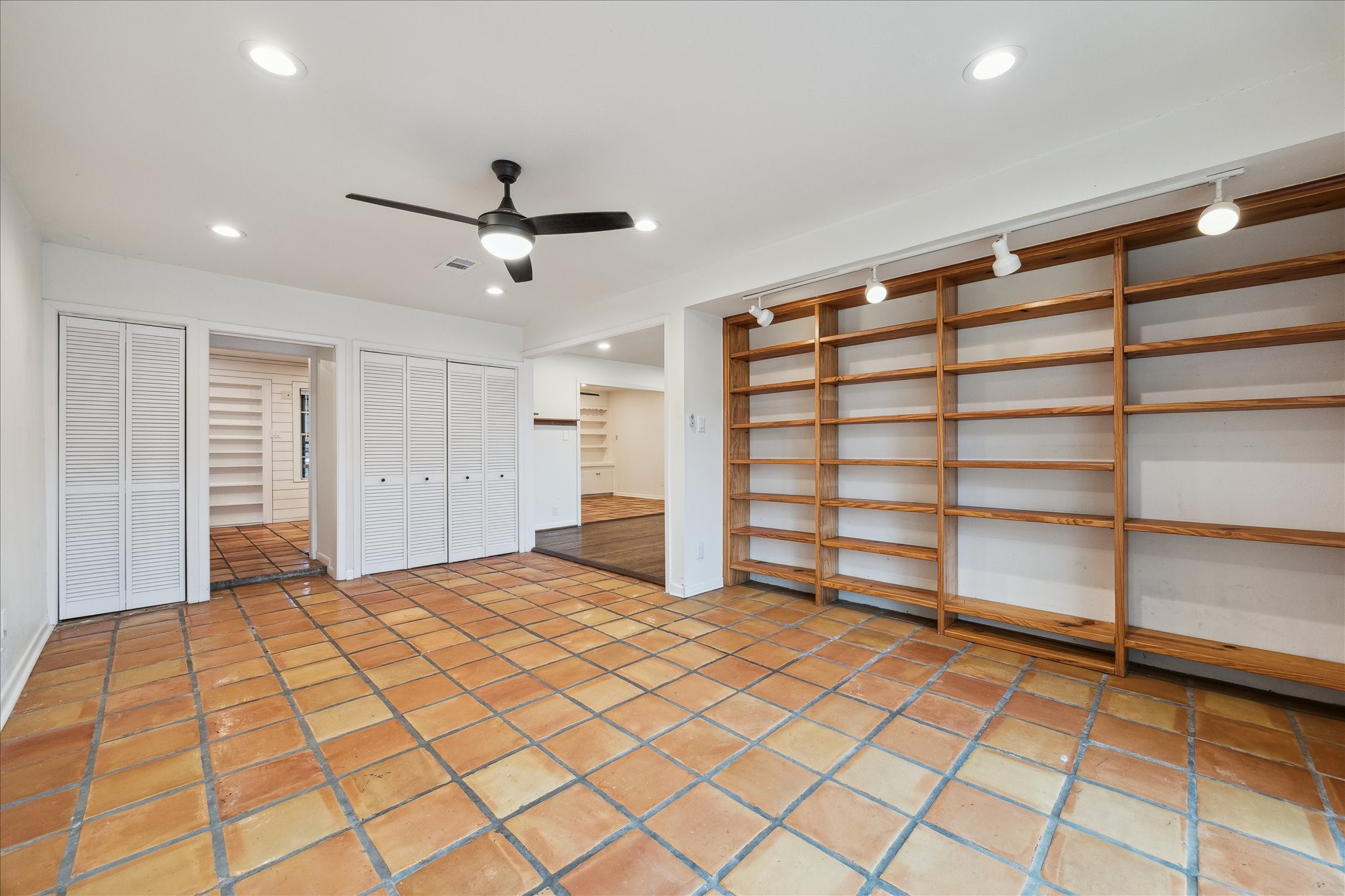 7262 Roos Road Houston, TX 77074 - Photo 11 of 25 a view of empty room with wooden floor and fan