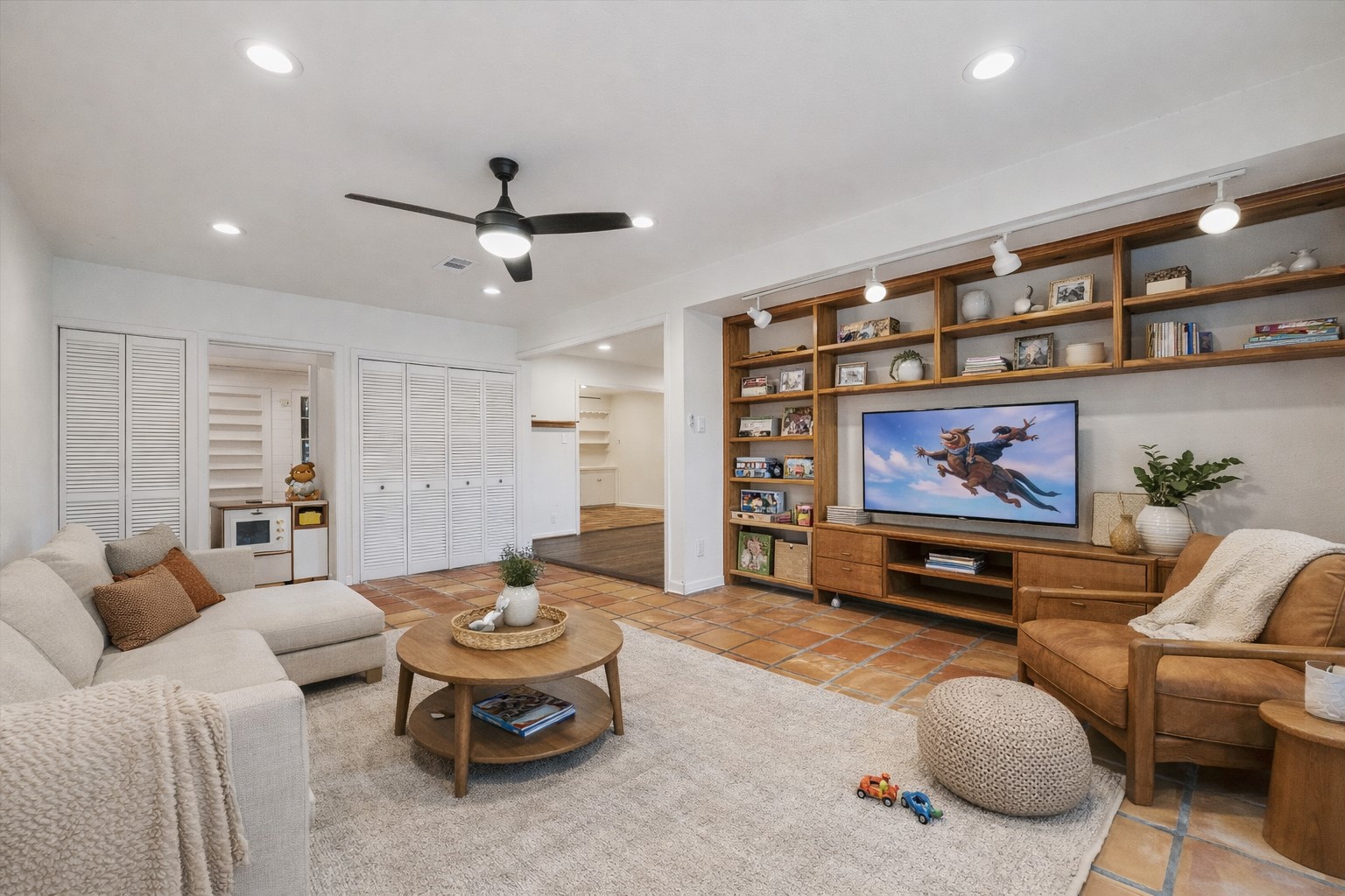 7262 Roos Road Houston, TX 77074 - Photo 2 of 25 a living room with furniture a rug and a wall painting