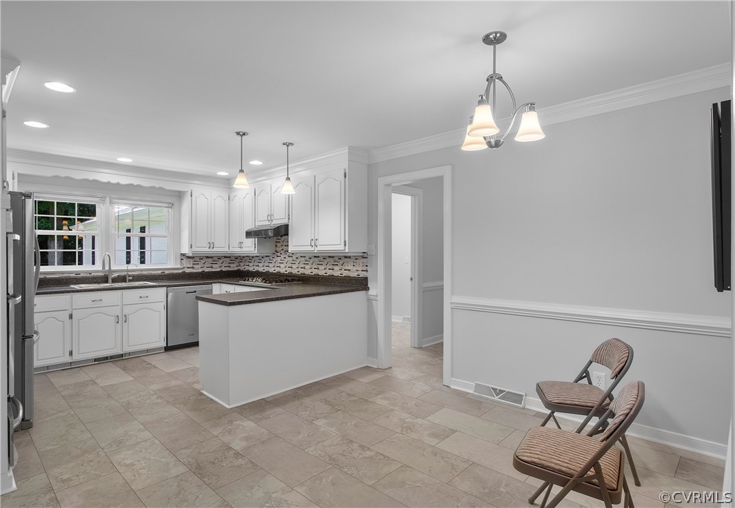 1503 Black Heath Road Midlothian, VA 23113 - Photo 13 of 50 a large white kitchen with cabinets a island and appliances