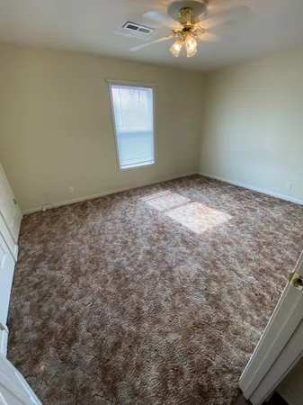a view of a big room with closet and chandelier fan