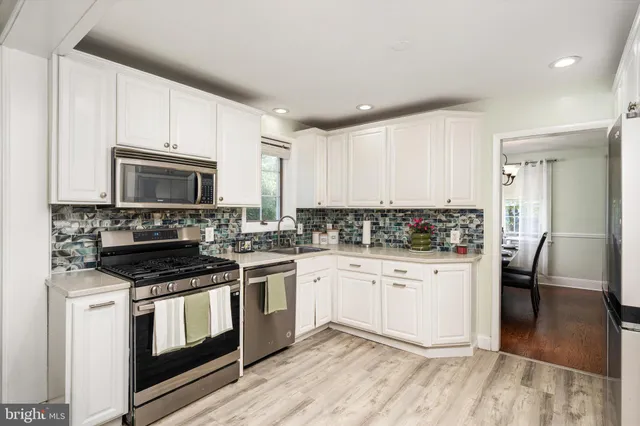 a kitchen with a stove a sink and a refrigerator