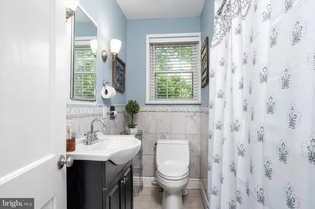 a bathroom with a sink a toilet and a window