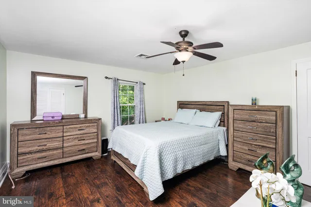 a bedroom with a bed dresser and a window