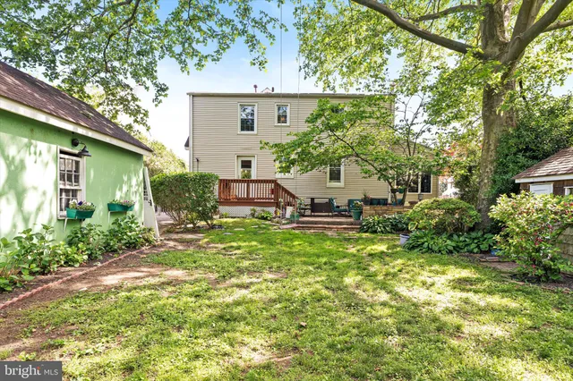 a view of a house with backyard sitting area and garden