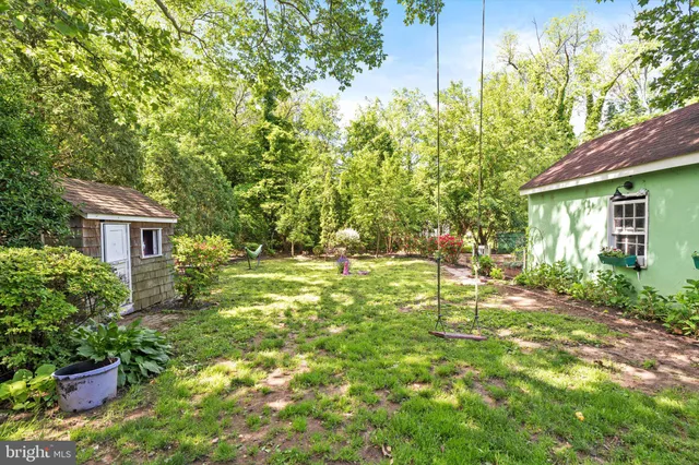 a view of house with backyard and garden