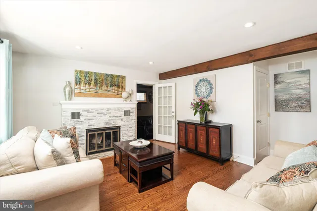a living room with furniture fireplace and window