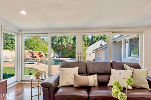 a living room with furniture potted plant and a table