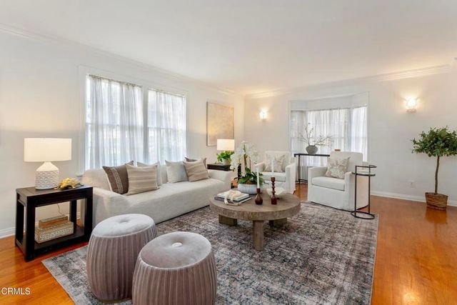 a living room with furniture a window and a table