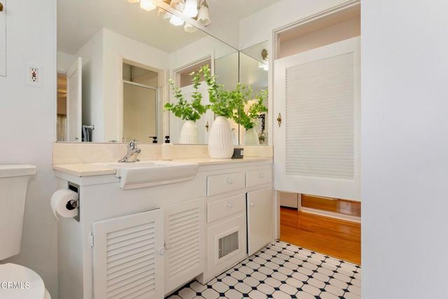 a bedroom with two beds and painting on the wall