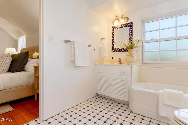 a bedroom with two beds and a chandelier