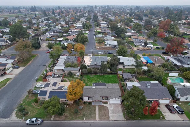 an aerial view of a house with a yard