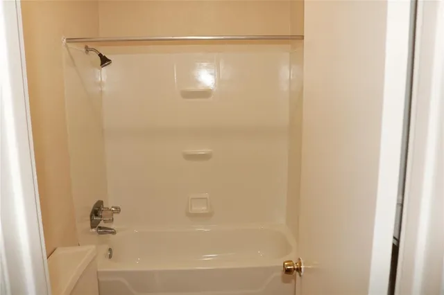 a bathroom with a shower and a bath tub