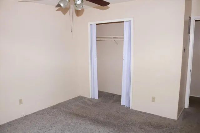 a view of a room with a ceiling fan