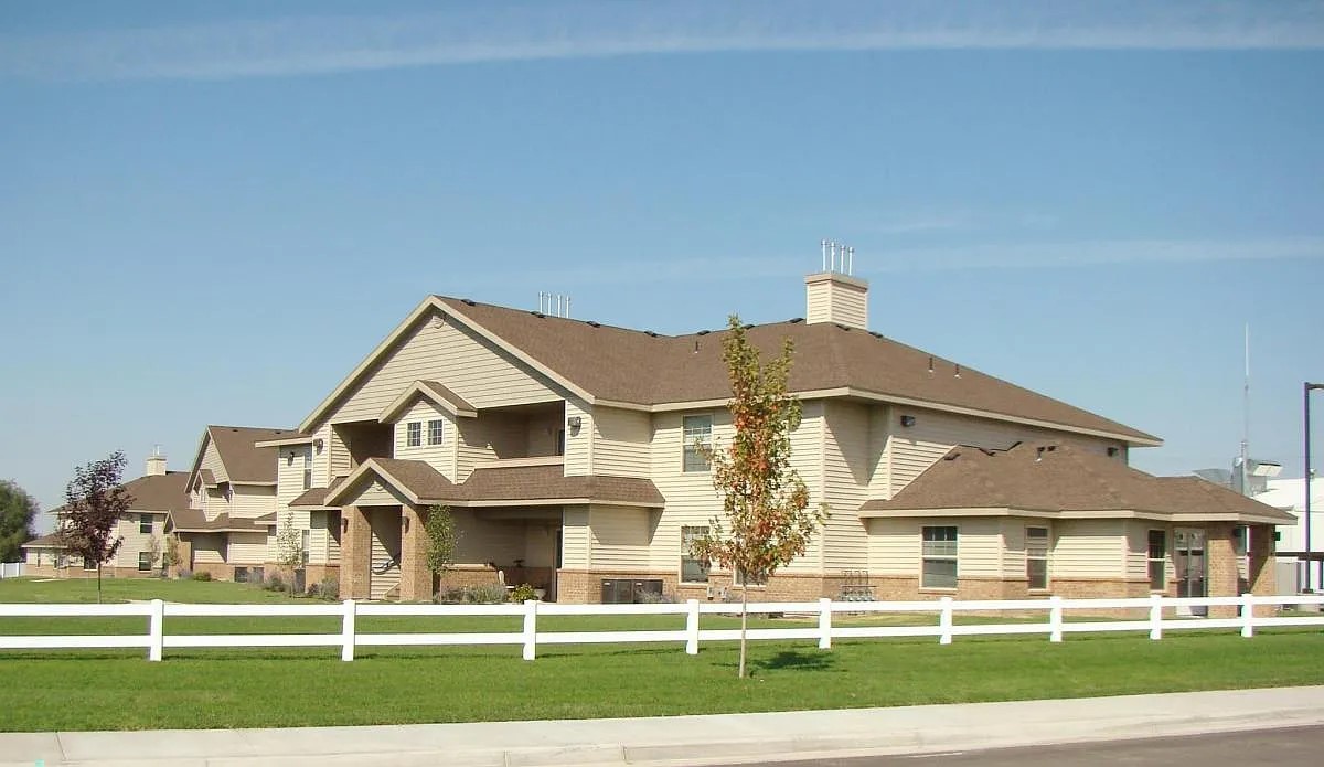 a front view of a residential houses with yard and green space
