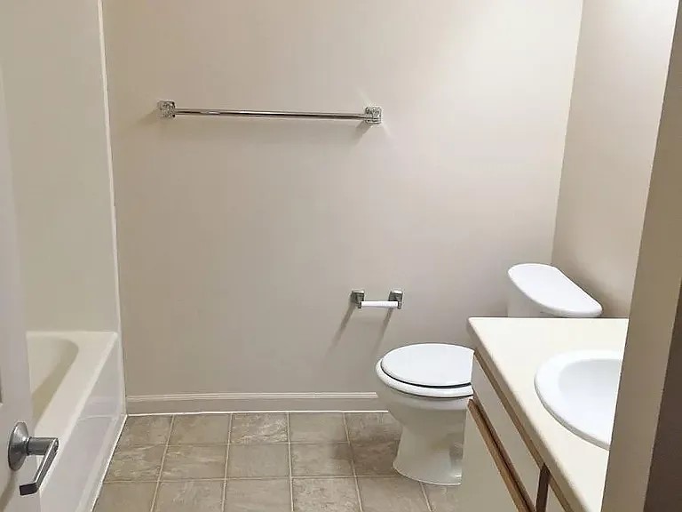 256 West 3rd Street Burley, ID 83318 - Photo 11 of 11 a white toilet sitting next to a bath tub and a shower