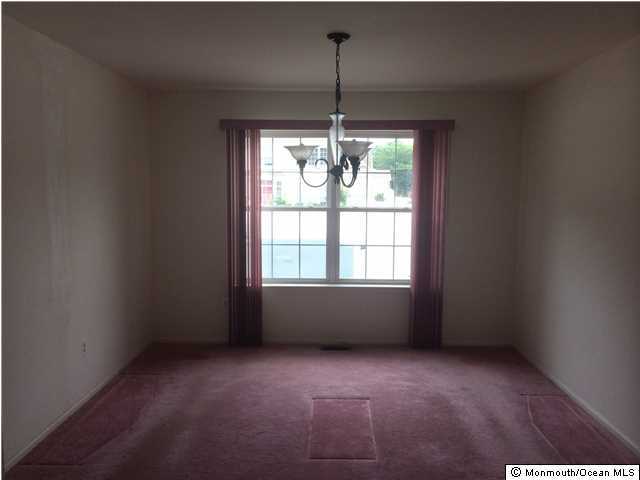 308 Compass Road Manahawkin, NJ 08050 - Photo 3 of 18 an empty room with windows and chandelier