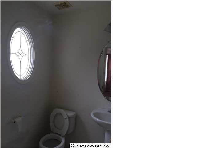 308 Compass Road Manahawkin, NJ 08050 - Photo 4 of 18 a bathroom with a toilet and a sink